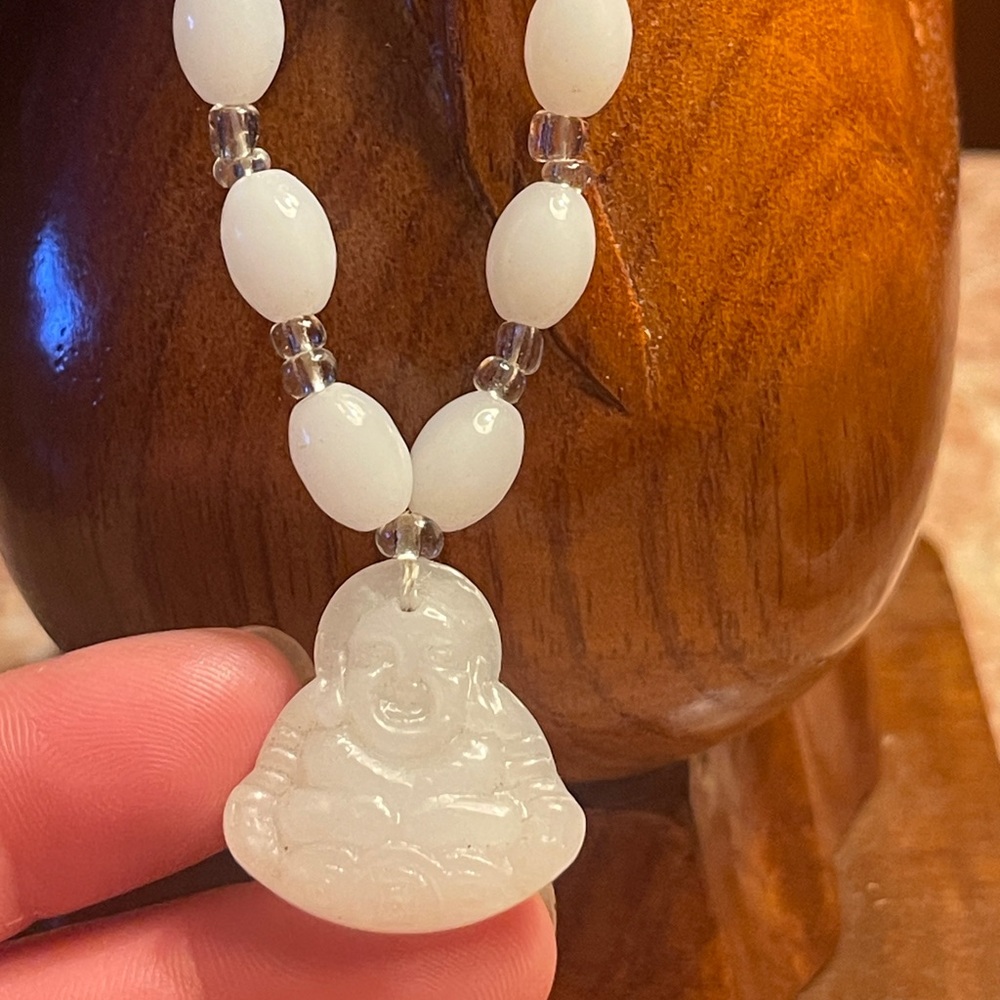 White, beaded necklace with Buddha pendant